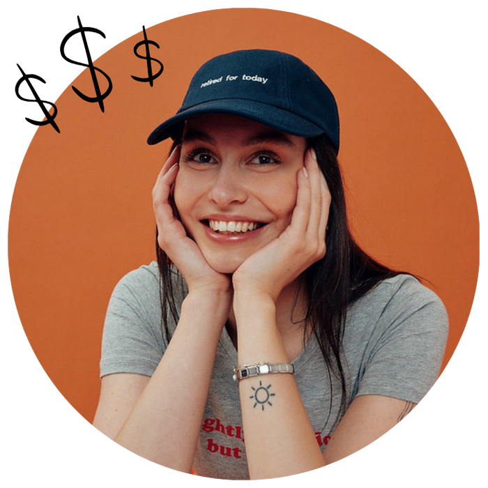 ecommerce seller wearing an embroidered cap with dollar signs to show profitability of print on demand